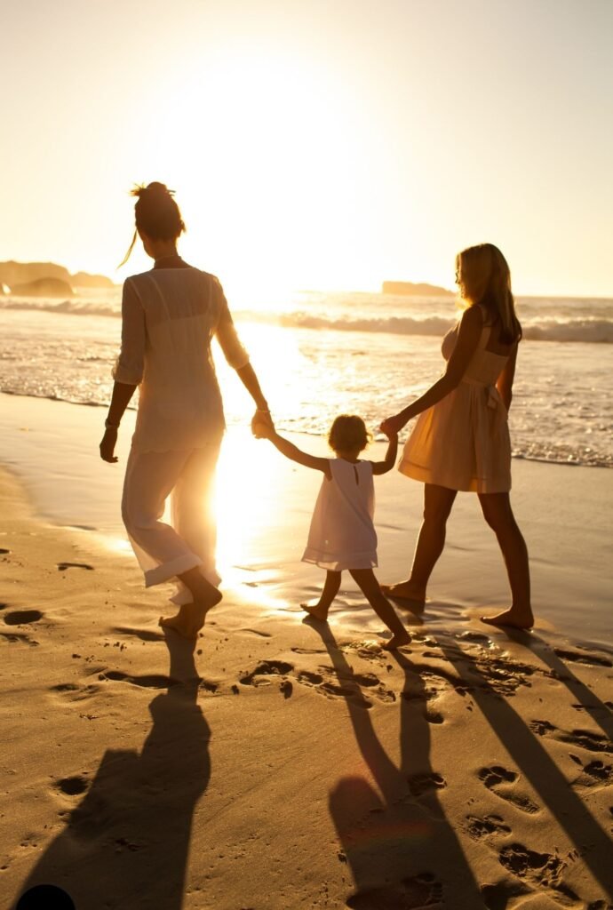 family-friendly luxury travel - mother and daughter on sunset beach