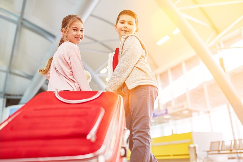 kids with a red suitcase 
