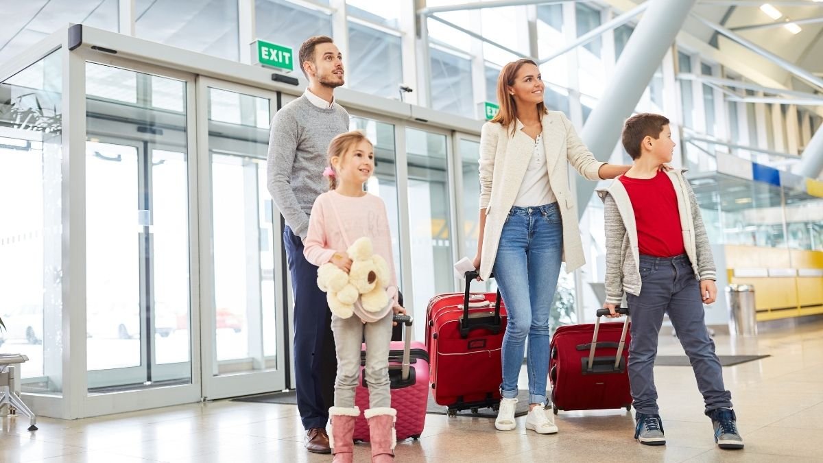 luxury family traveling through airport with luggage - parents and children walking together for stress - free vacation tips (2025 family travel hacks)