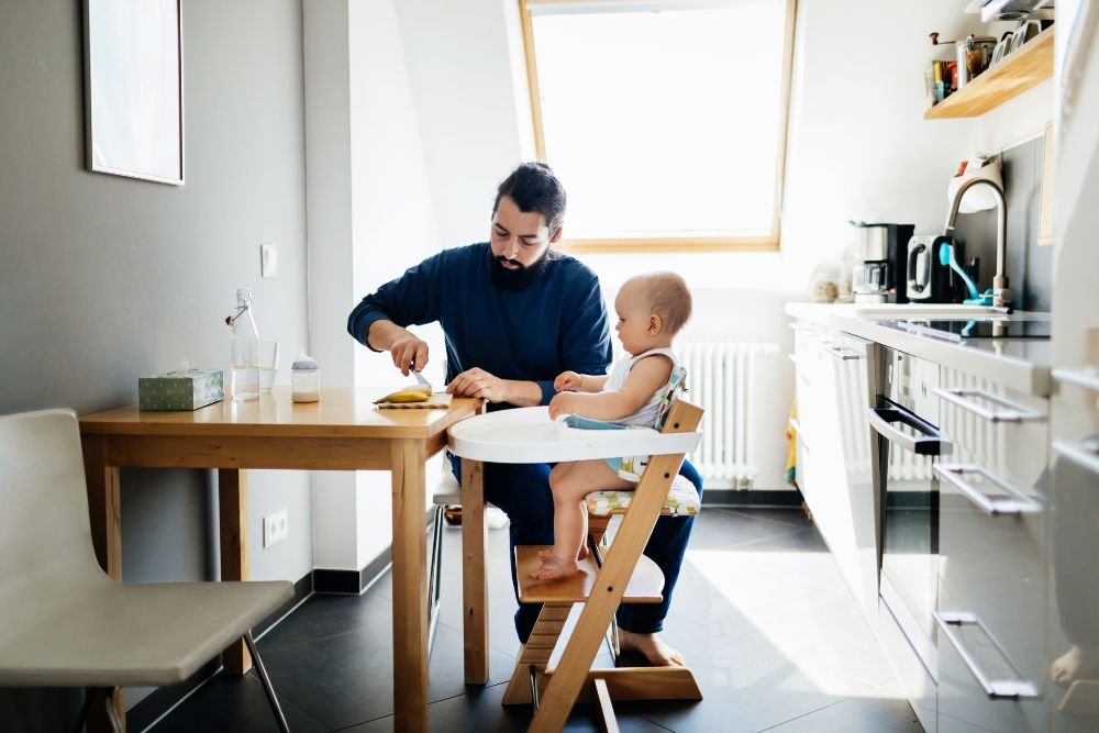 baby in high chair in modern apartment