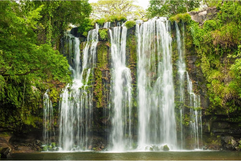 Scenic waterfall surrounded by lush rainforest in Costa Rica, a popular eco-luxury travel destination.